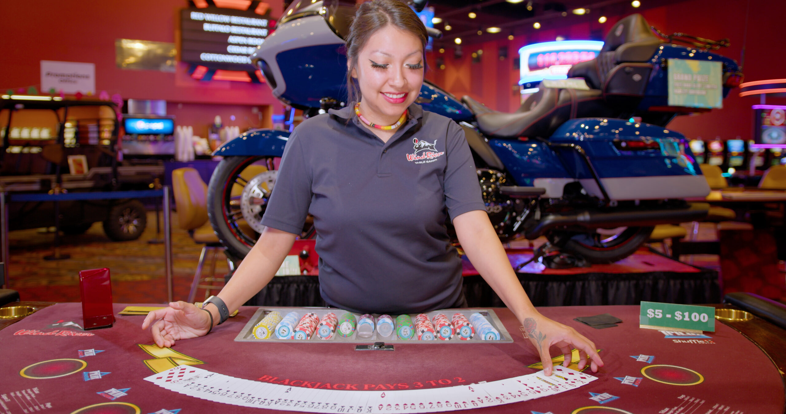 Wind River Hotel Casino Table Games Dealer with cards spread out